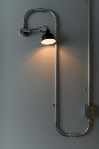 a light hanging on a wall in a room at etoe Hotel Shinjuku in Tokyo