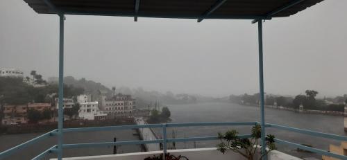 a view of a river with buildings in the distance at Gladden Villa in Udaipur