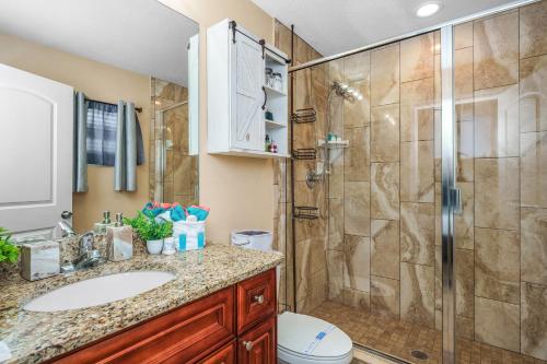 a bathroom with a shower and a sink and a toilet at Channel Side,Down Town Tampa ,Ybor Palmetto Beach with pickle ball court in Tampa