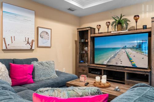 a living room with a couch and a large screen tv at Channel Side, Down Town Tampa ,Ybor Palmetto Beach, Hot tub, with pickle ball court in Tampa