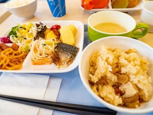 a tray with three plates of food on a table at Toyoko Inn Kobe Sannomiya Ekimae in Kobe