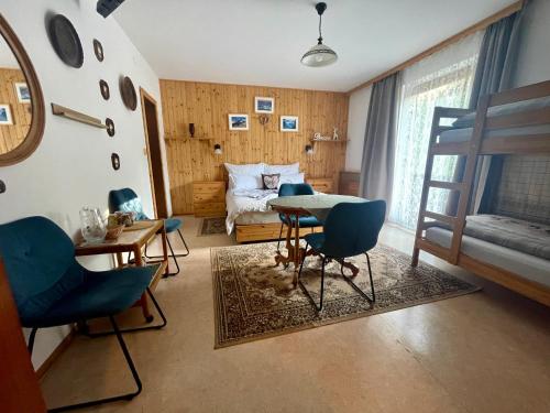 a room with a bed and a table and chairs at Alpenpension Gasthof in Ratten