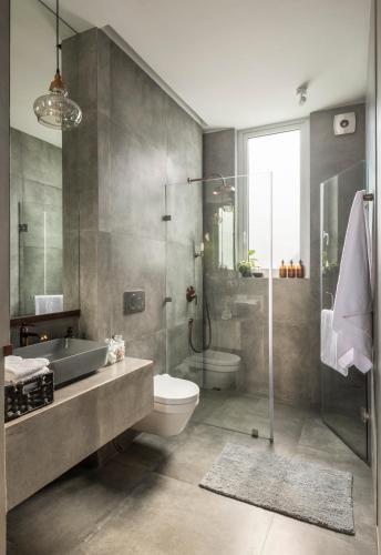 a bathroom with a sink toilet and a shower at La Olalian 2 & 3 BHK Designer Villas Near Anjuna Beach with Private Pool & Sun Deck & Garden in Anjuna