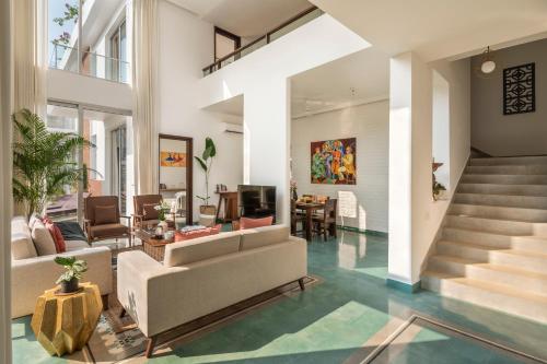 a living room with a couch and a table at La Olalian 2 & 3 BHK Designer Villas Near Anjuna Beach with Private Pool & Sun Deck & Garden in Anjuna
