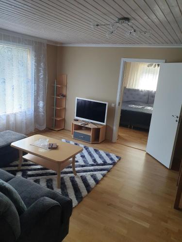 a living room with a couch and a table at Kuressaare Centrum in Kuressaare