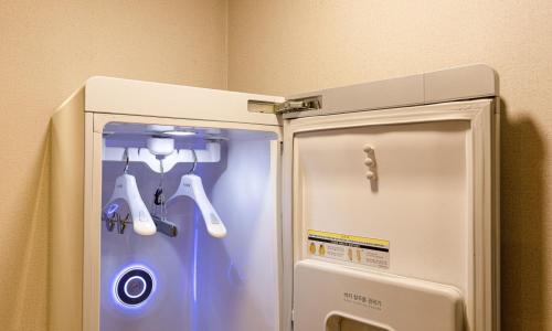 a refrigerator with its door open in a room at Anyang CNC Hotel in Anyang