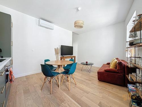 un salon avec une table et des chaises bleues dans l'établissement Magnifique Appartement - Centre du Panier - Design - Les Frères de la Loc', à Marseille