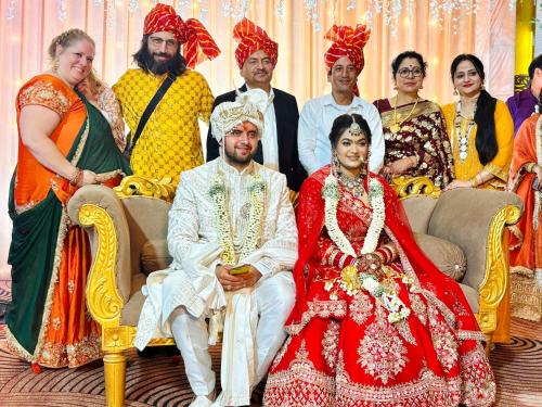 a group of people posing for a picture at a wedding at Feel at Home Tranquil trails home stay naddi in Dharamshala
