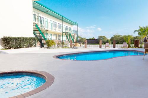 a swimming pool in front of a building at Marina Inn & Suites Chalmette-New Orleans in Chalmette