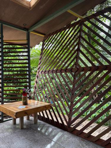 a wooden wall with a wooden table on a patio at Orgánico Punta Riel in Cahuita