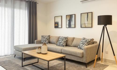 a living room with a couch and a table at Ultramodern 2 bedroom space Available in Accra