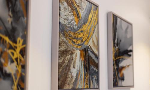 three framed paintings of a woman on a wall at Ultramodern 2 bedroom space Available in Accra