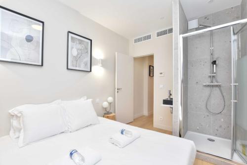 - une chambre avec un lit blanc et une douche dans l'établissement Peaceful apartment - 2BR-6P - Trocadero, à Paris