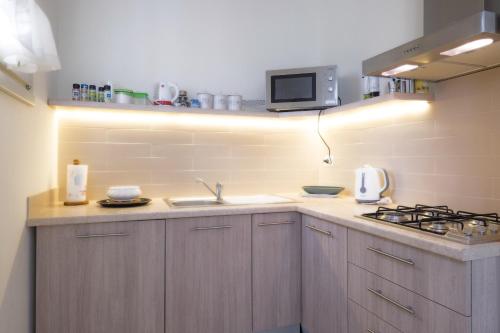 a kitchen with a sink and a stove at Corte Elvira in Manerba del Garda