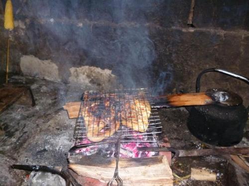 a grill with a bunch of hot dogs on it at Soi Local Guest House in Sa Pa