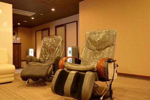 a room with a chair and a bag on the floor at Diamond Hakone Society in Hakone