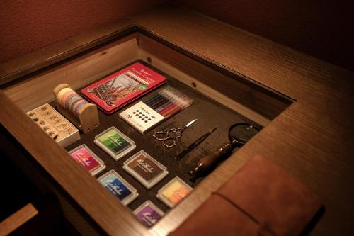 a drawer with a bunch of buttons and scissors at Mansion Bridge Gunsan in Gunsan