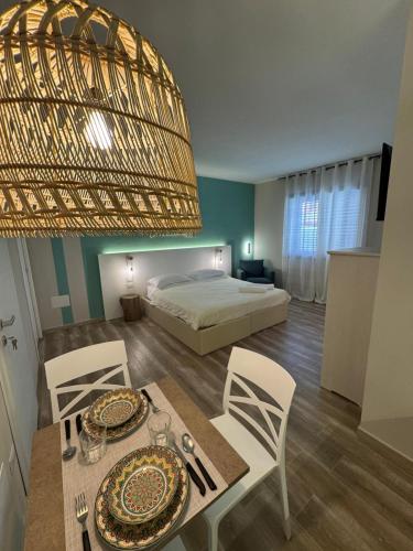 a bedroom with a bed and a table and chairs at RC Sardinia in Sorso
