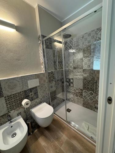 a bathroom with a toilet and a sink and a shower at RC Sardinia in Sorso