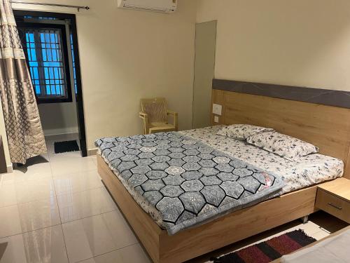 a bedroom with a large bed with a wooden headboard at BSR plaza in Elūru