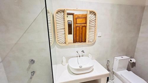 a bathroom with a sink and a mirror at K1 by Ceilao villas in Ahangama