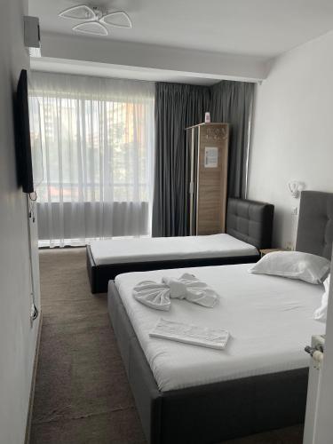 a hotel room with two beds and a window at HOTEL Vitan273 in Bucharest