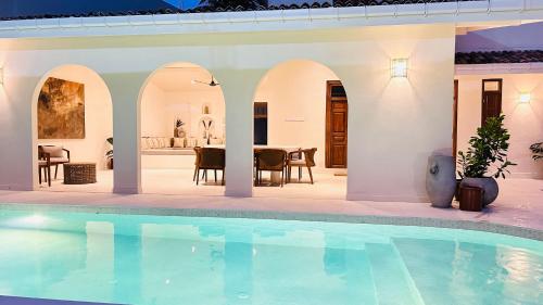 a villa with a swimming pool and a dining area at K1 by Ceilao villas in Ahangama