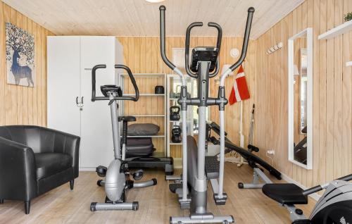 a gym with two exercise bikes and a chair at Holiday Home Ajstrup Strandvej Malling Xi in Malling