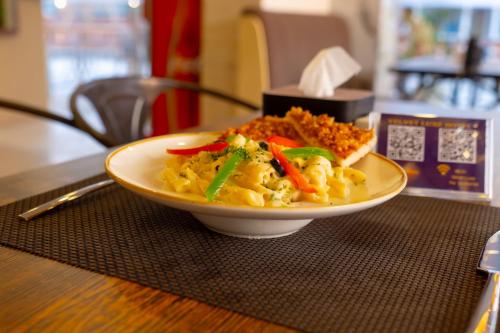 a plate of food sitting on a table at Velvet Luxe Hotel in Jogīkuti