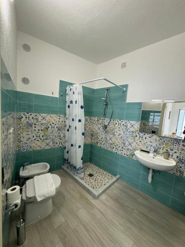 a bathroom with a shower and a toilet and a sink at Villa Chiena Forio in Ischia