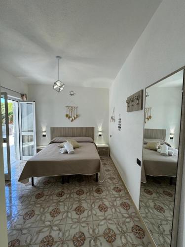 a bedroom with two beds and a mirror at Villa Chiena Forio in Ischia