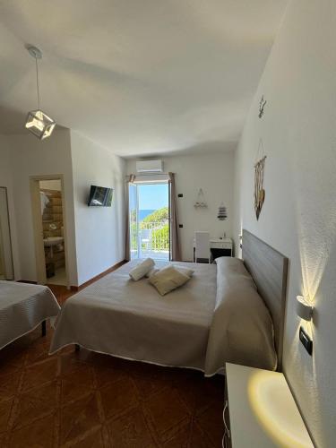 a bedroom with a large bed and a window at Villa Chiena Forio in Ischia