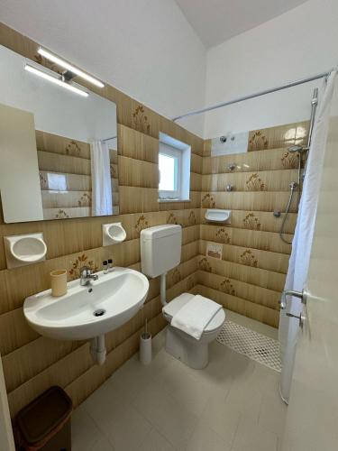 a bathroom with a sink and a toilet and a mirror at Villa Chiena Forio in Ischia