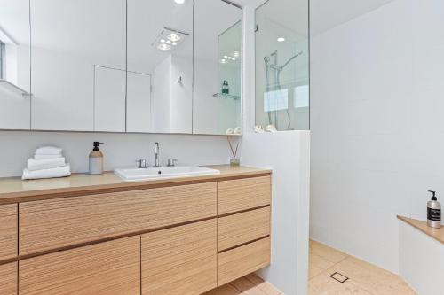 a bathroom with a sink and a mirror at Little Cove Court - Apt 5 Newly Renovated in Noosa Heads