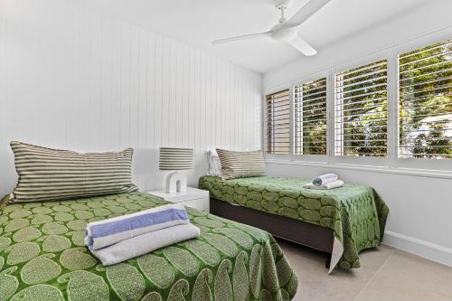 a bedroom with two beds and a window at Little Cove Court - Apt 5 Newly Renovated in Noosa Heads