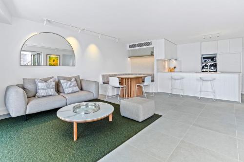 a living room with a couch and a table at Little Cove Court - Apt 5 Newly Renovated in Noosa Heads