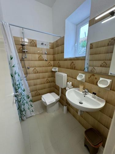 a bathroom with a toilet and a sink at Villa Chiena Forio in Ischia