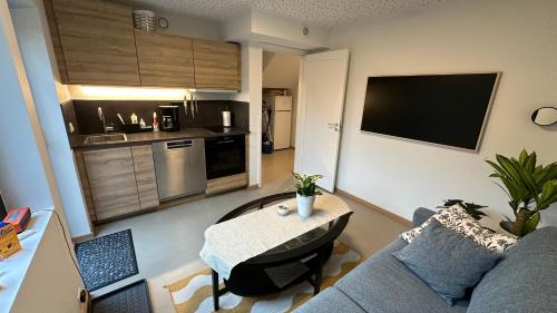 a living room with a blue couch and a table at Modern and comfortable apartment in attractive neighborhood in Stavanger