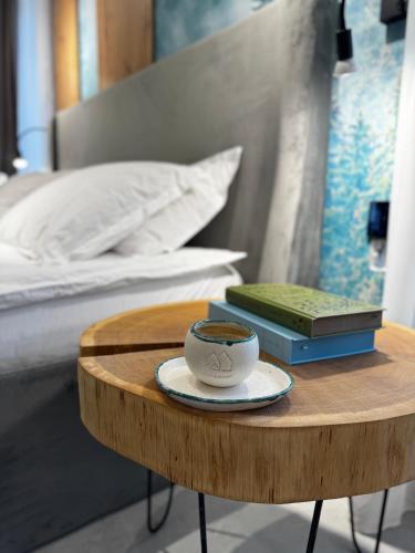 a cup of coffee on a table next to a bed at MAPaMONT in Văliug