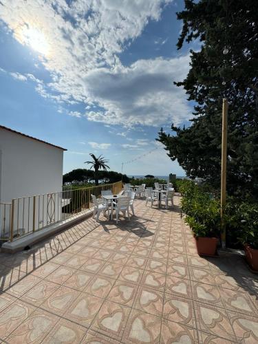 a patio with a bunch of chairs and tables at Villa Chiena Forio in Ischia