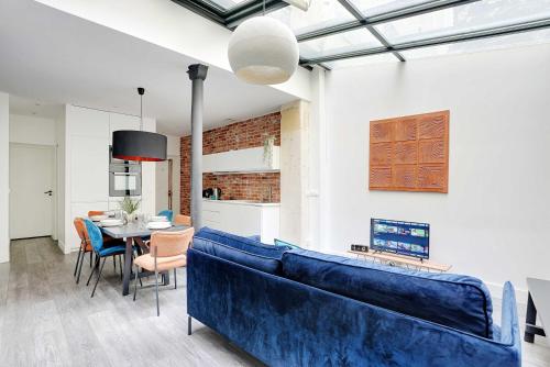 un salon avec un canapé bleu et une table dans l'établissement Splendid apartment - 2BR 4P - Sacré-Cœur, à Paris