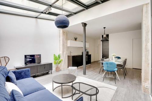 un salon avec un canapé bleu et une table dans l'établissement Luminous apartment 4P2BD Sacré-Coeur Montmartre - G, à Paris