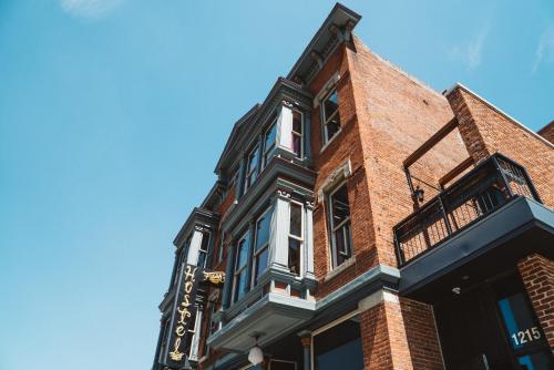 a red brick building with a black and white facade at Hostel Fish in Denver