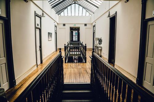 a hallway with stairs in a building with a glass ceiling at Hostel Fish in Denver