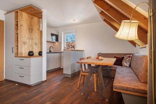 a kitchen and living room with a table and a couch at Obst- und Ferienhof Lehle in Immenstaad am Bodensee