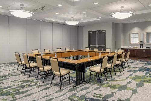 a large conference room with a large table and chairs at Embassy Suites Fort Myers - Estero in Estero