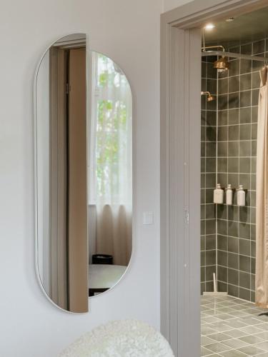 a bathroom with a mirror and a shower at Grønbechs Hotel in Allinge