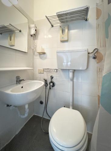 a bathroom with a toilet and a sink at Hotel Meublè Agavi in Monterosso al Mare