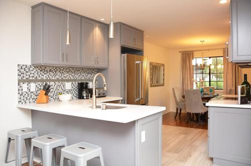 a kitchen with a sink and some stools in it at Sonoma Hideaway 3BD 2,5 BATH, Beautiful Patio and Garden in Sonoma
