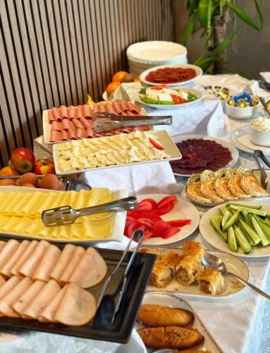 a table filled with lots of different types of food at Hotel Previla in Sarajevo